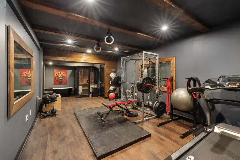 A modern home gym setup with weights, treadmill, and fitness equipment
